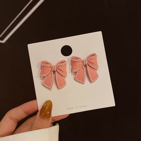 Korean pearl black bow earrings wholesale's discount tags