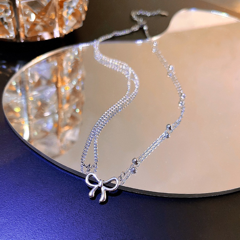 Korean design sense asymmetric bow titanium steel necklace female fashion clavicle chain