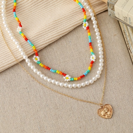 neue mehrschichtige Stapelung Gänseblümchenreisperlen herzförmige geprägte Perlenkette Großhandel's discount tags