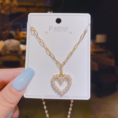 Collar de cobre de cadena corta de cadena de clavícula en forma de corazón con incrustaciones de perlas de moda al por mayor
