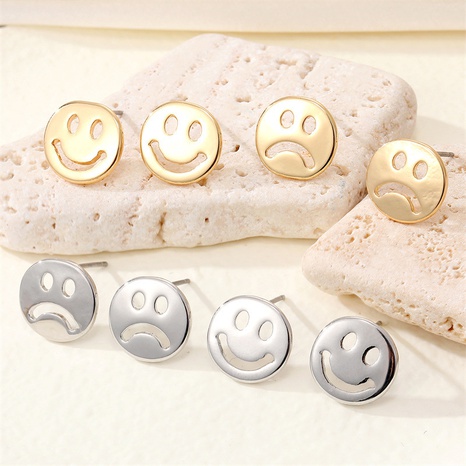 Korean new personality cute alloy hollow smile crying face earrings wholesale's discount tags