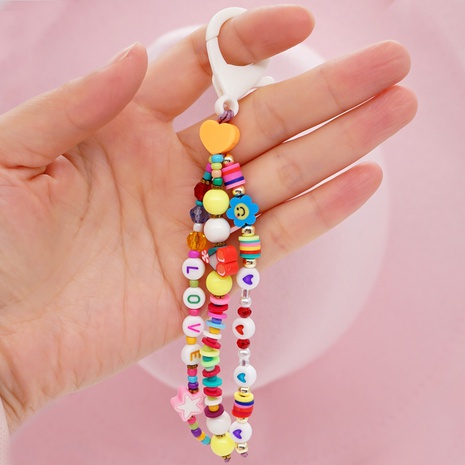 Simple bohemian style handmade beaded soft pottery smiling face keychain's discount tags