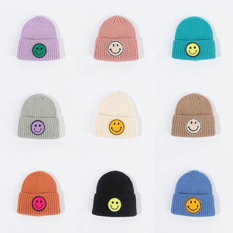 Korean winter children's smiling face knitted hat cute candy color warm hood woolen cap's discount tags