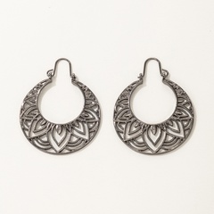 Nihaojewelry jewelry wholesale ethnic hollow metal carved rotating earrings