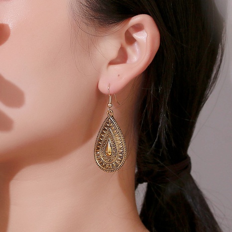 Nihaojewelry wholesale jewelry ethnic style peacock tail-shaped carved earrings's discount tags