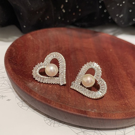fashion pearl hollow heart-shaped inlaid zircon copper earrings wholesale NHWK623045's discount tags