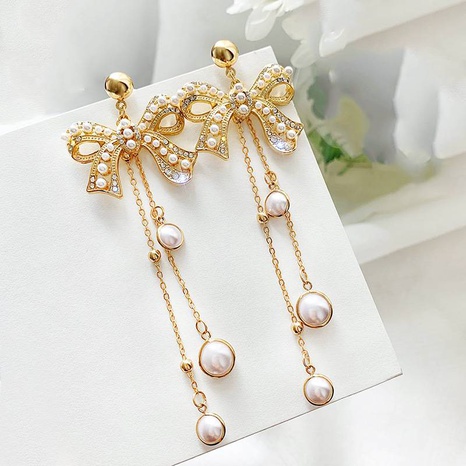 Fashion hollow bow exaggerated pearl tassel earrings wholesale  NHYSL629328's discount tags