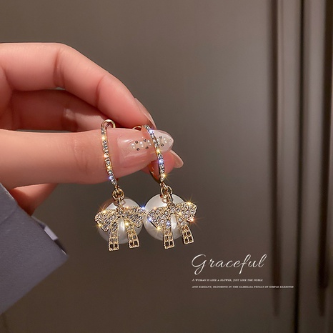 Korean fashion earrings pearl diamond bow alloy earrings wholesale's discount tags