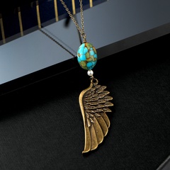 collier pendentif turquoise incrusté d'ailes d'aigle sculptées de plumes rétro