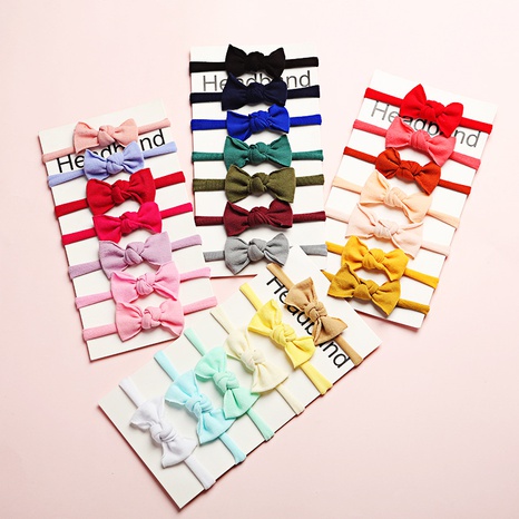 neues, einfarbiges, superweiches und nahtloses Nylon-Baby-Stirnband mit niedlicher Schleife aus Gummiband's discount tags