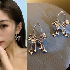 Fashion water drop bow rhinestone knotted hollow alloy earrings