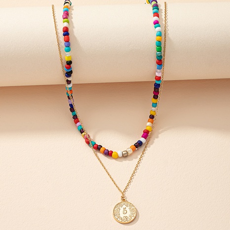 Modische Farbperlen die eine weibliche Regenbogen-Perlenkette stapeln's discount tags