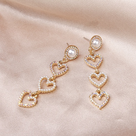 cute hollow heart pearl cute tassel long earrings's discount tags